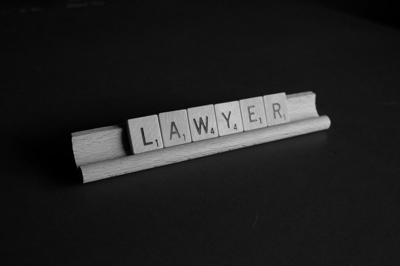 The word "lawyer" (barrister vs solicitor) spelled in Scrabble pieces