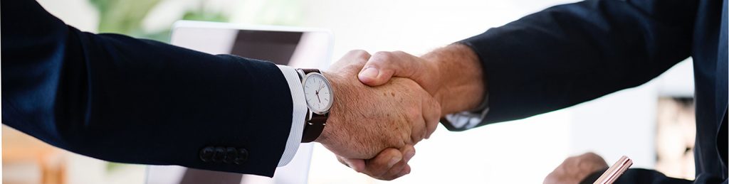 close up of a man's hand shaking hands with a male team member from Owen Hodge Lawyers Sydney