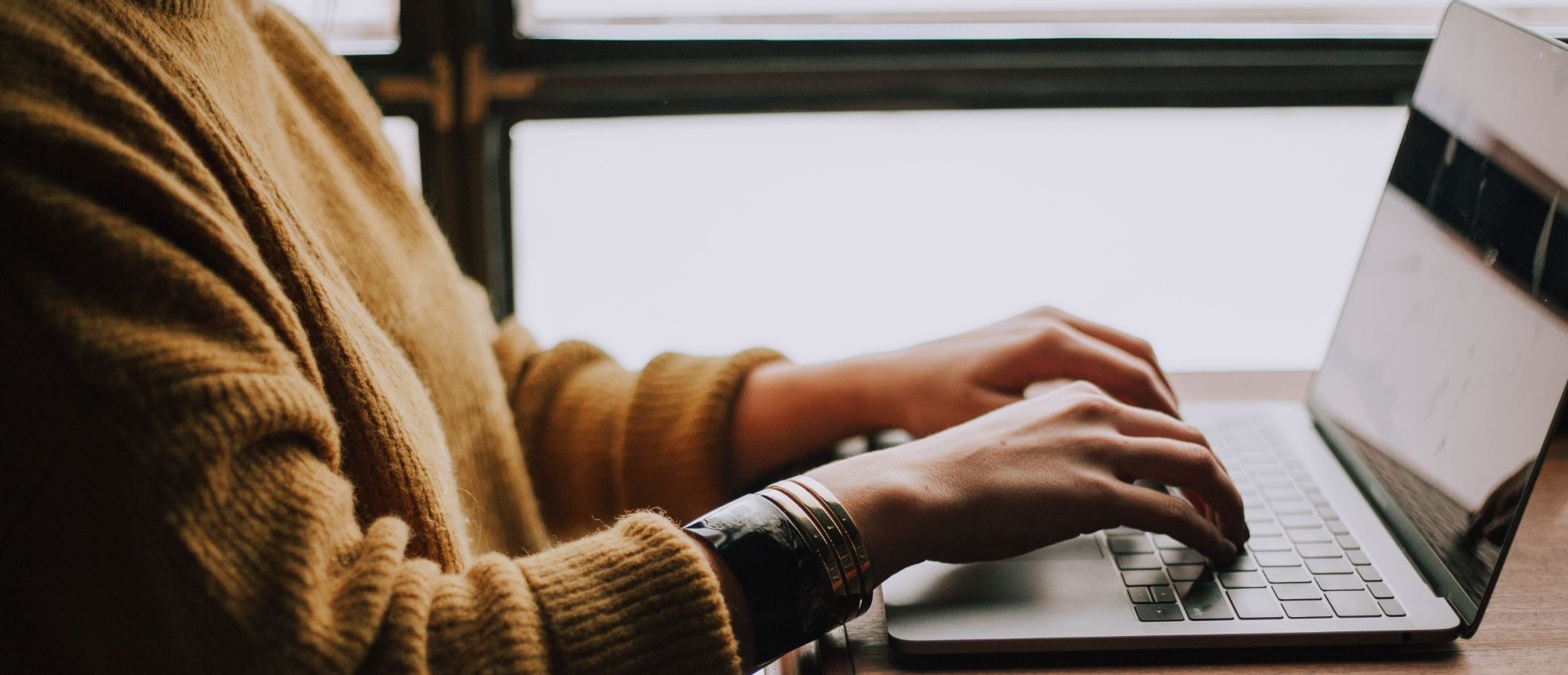 woman researching on a laptop about public liability lawyers