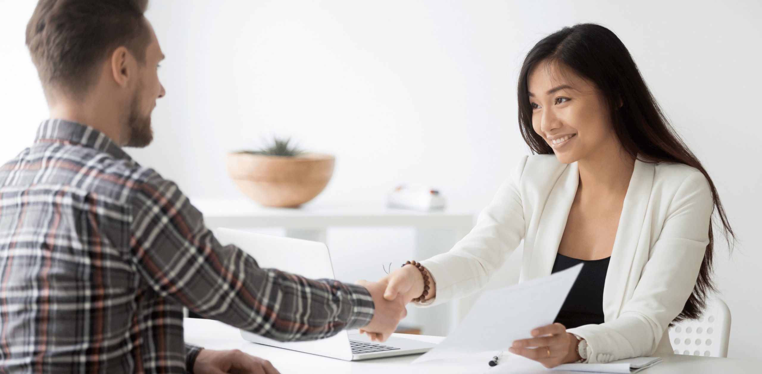 a man and a woman agreeing on an employment contract