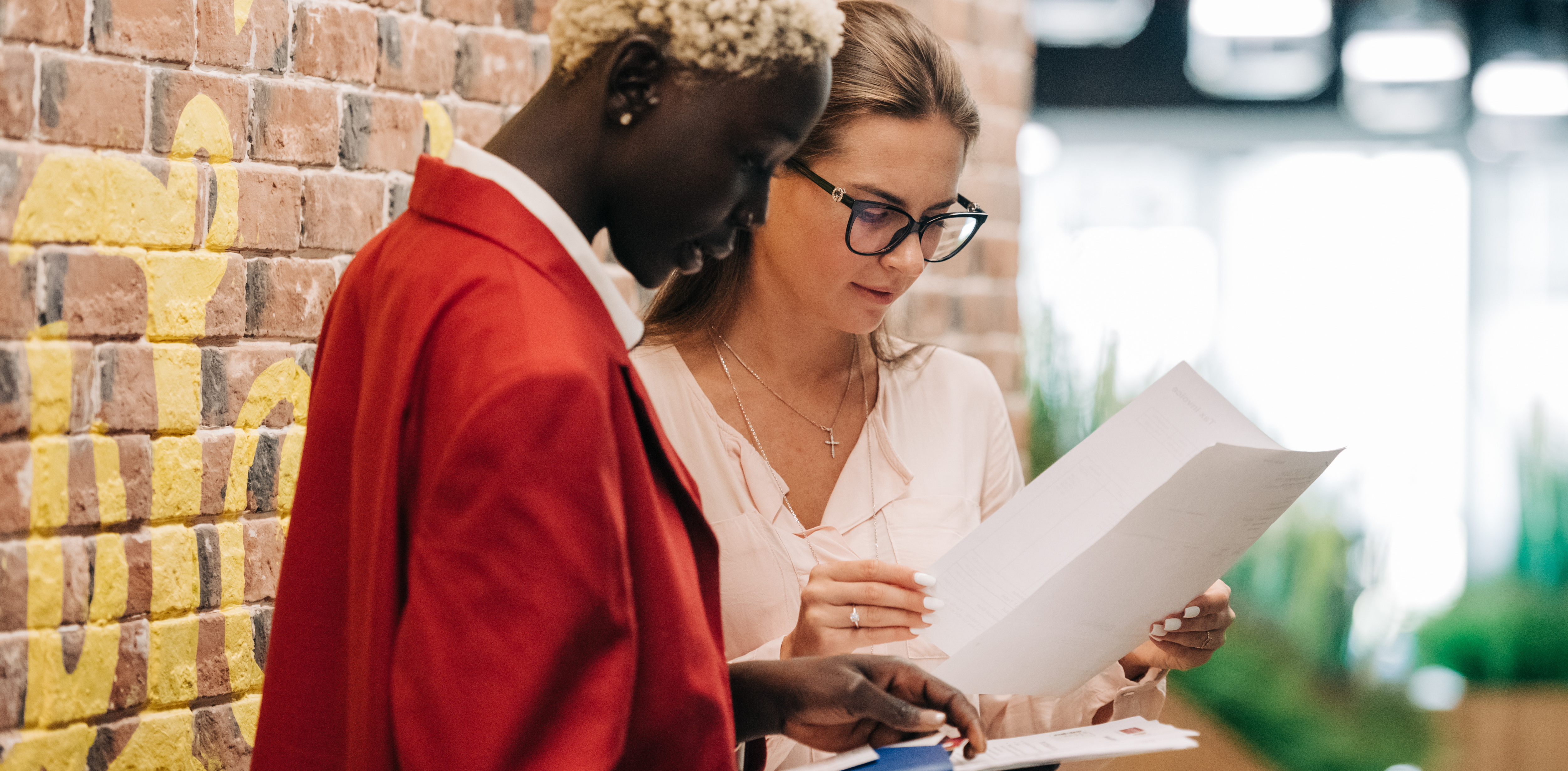 two women looking at an executive employment agreement